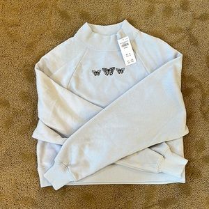 Light blue cropped crew neck.
